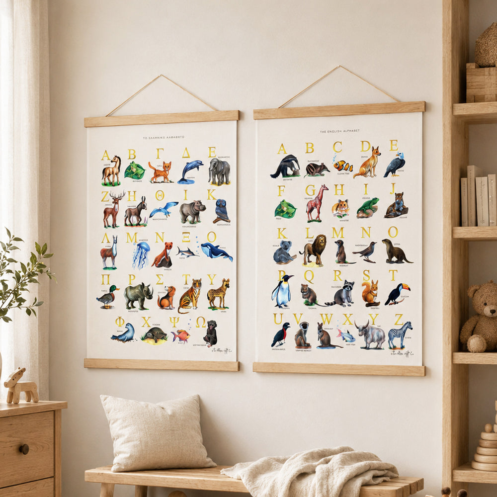 Two framed educational animal posters hanging on a beige wall in a styled nursery or children's room. The room includes a wooden shelf with books and a teddy bear, a bench with a throw blanket, and a small plant.